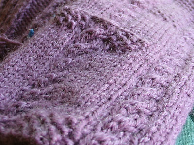Left front pocked of the cable and seed stitch cardigan